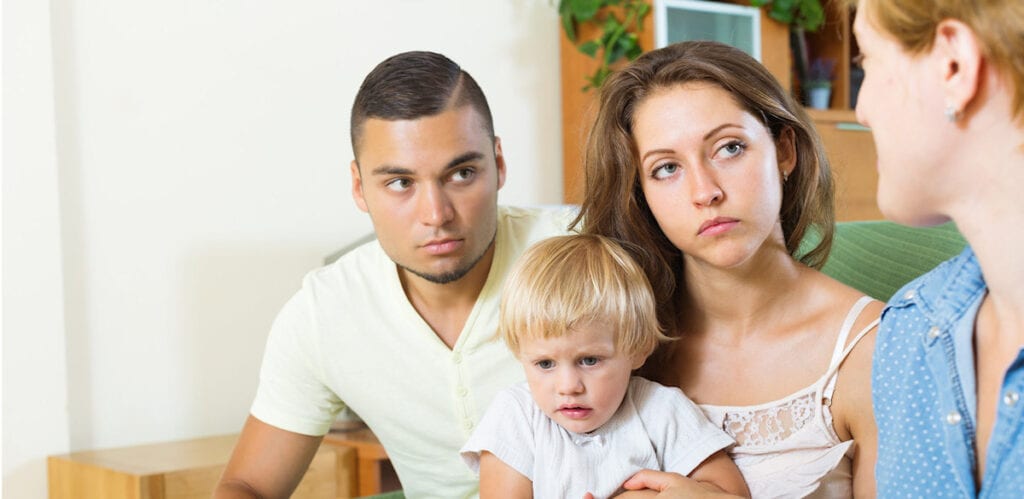 Unhappy family with tense expressions at home.