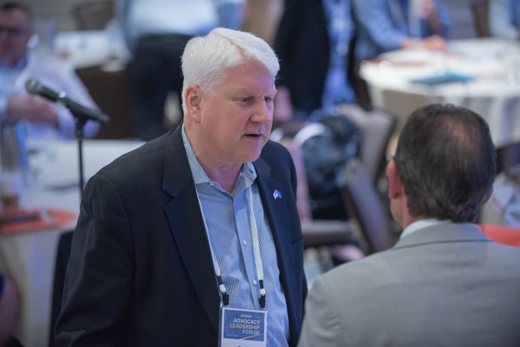 Two men engaged in conversation at a professional event.