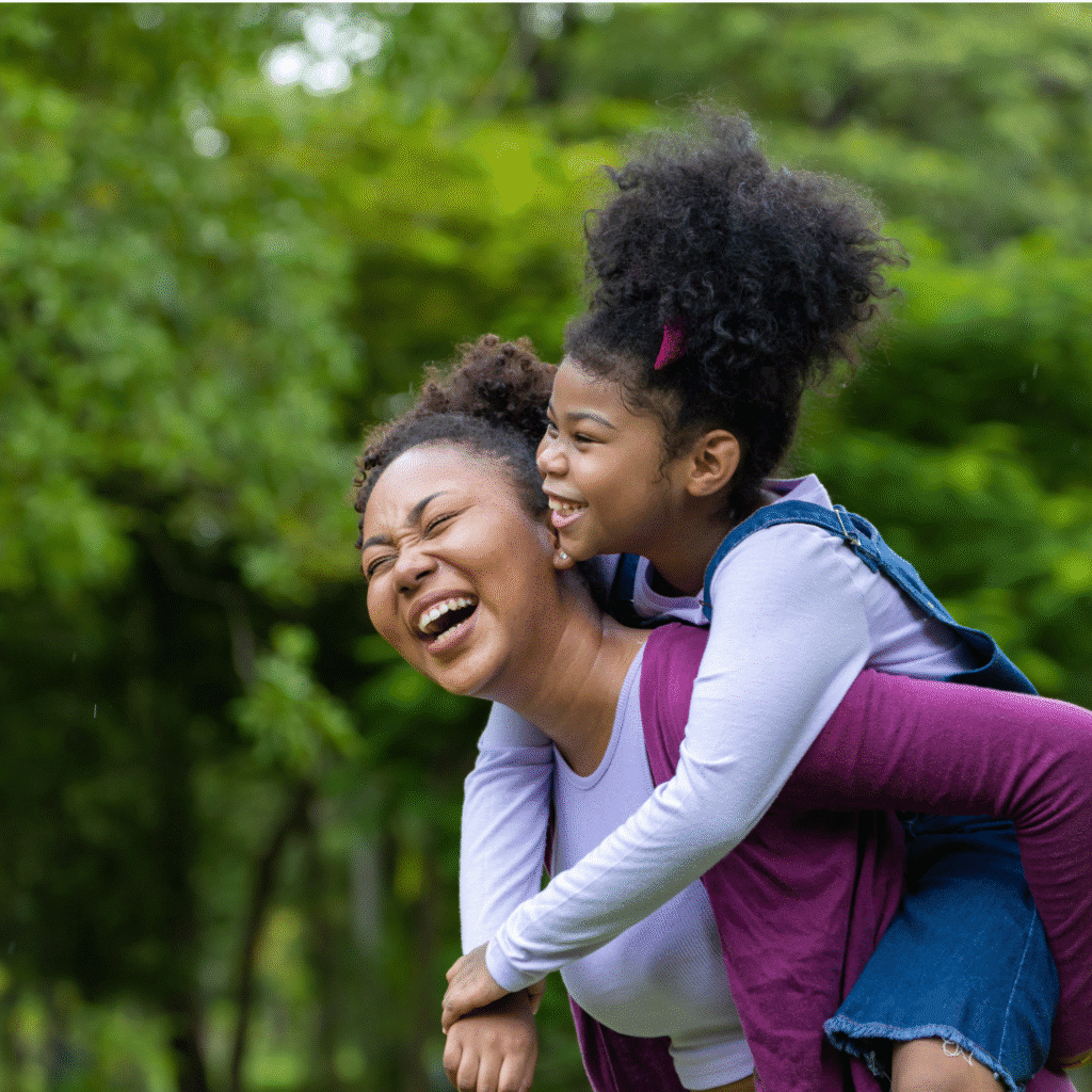 Girl riding piggy back on mom